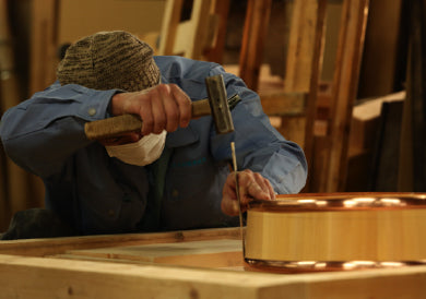 Japanese craftsman building a wooden bath tub
